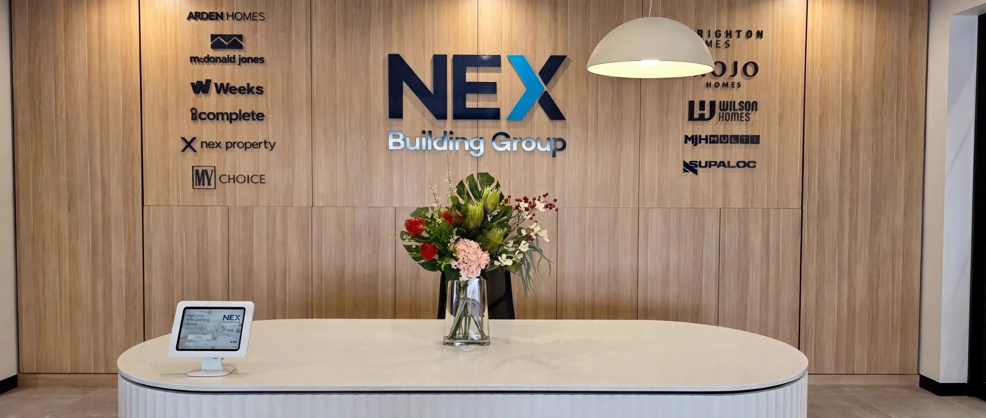 Curved stone reception desk at the NEX Building Group offices in Newcastle